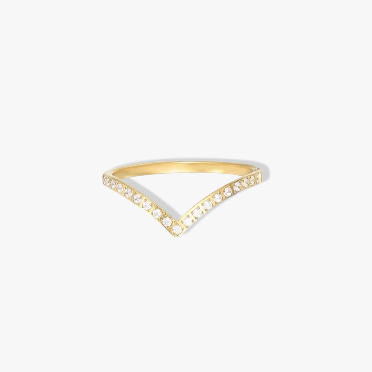 Gold wishbone ring with small clear gemstone detail along the band. Pictured on a white background