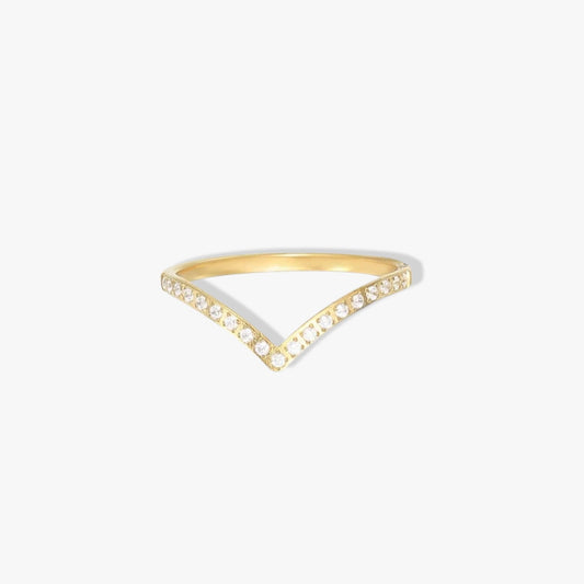 Gold wishbone ring with small clear gemstone detail along the band. Pictured on a white background