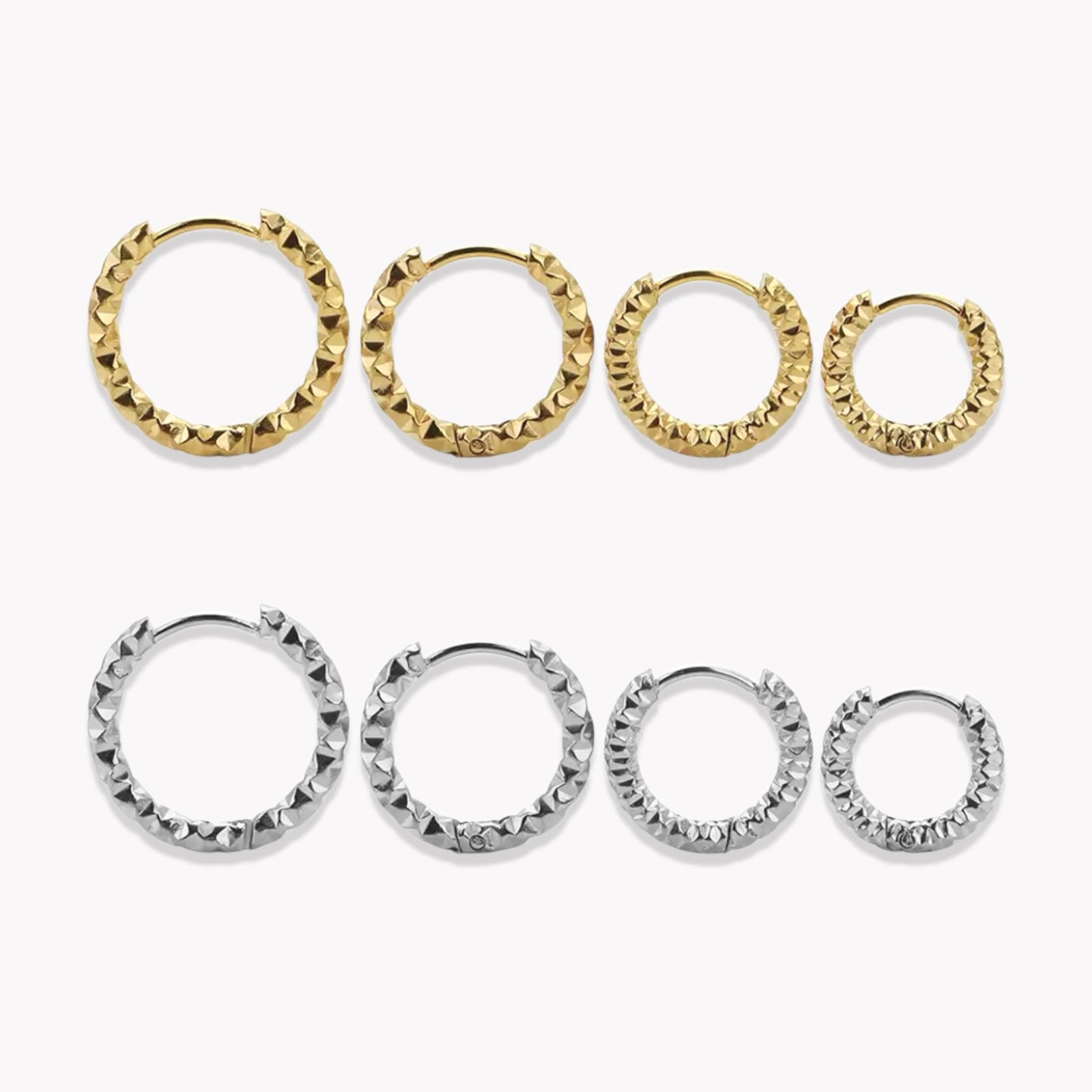 4 pairs of gold and silver hooped earrings in different sizes, organised from biggest to smallest pictured on a white background