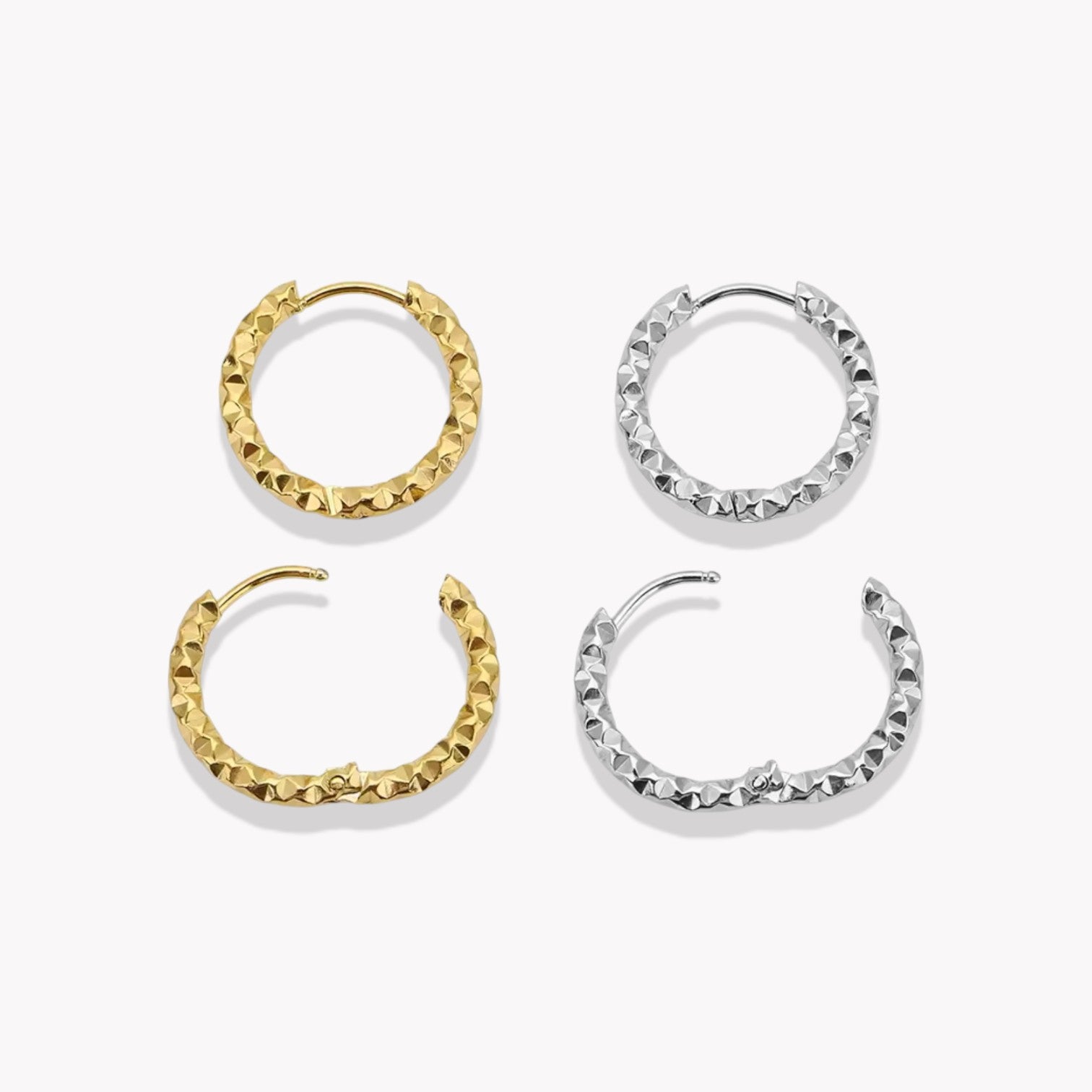Gold and silver hooped earrings being shown in an open and closed position, pictured on a white background