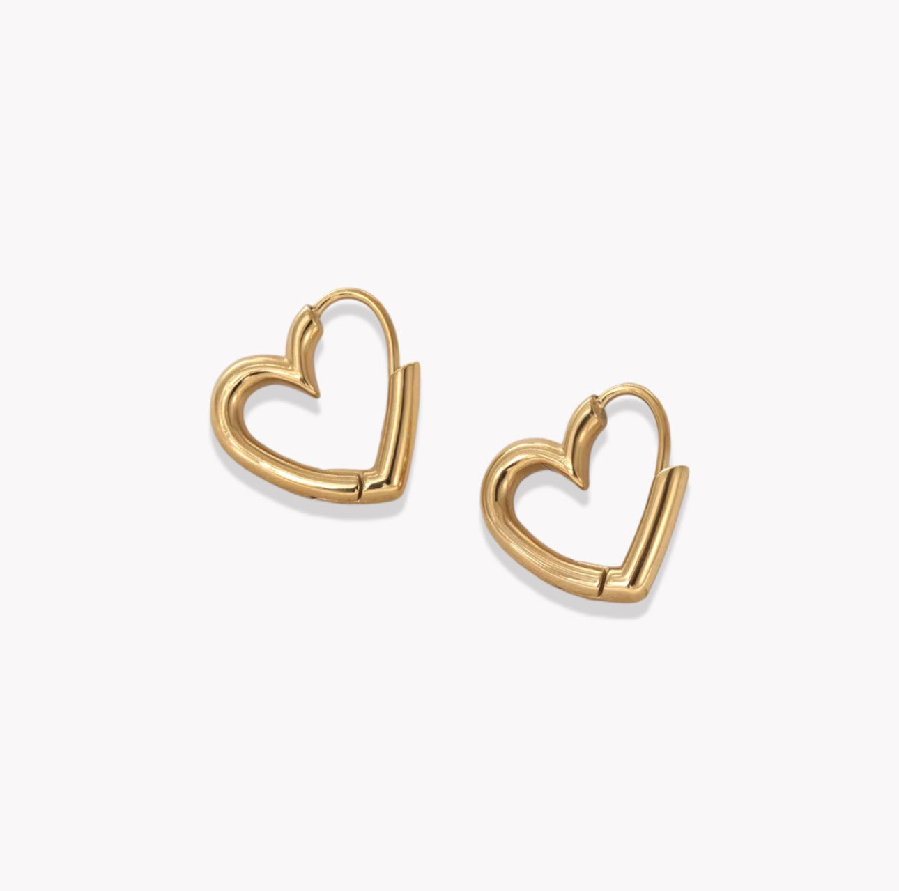 Gold heart-shaped hoop earrings on a white background