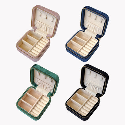 Four open jewelry boxes in different colors on a white background