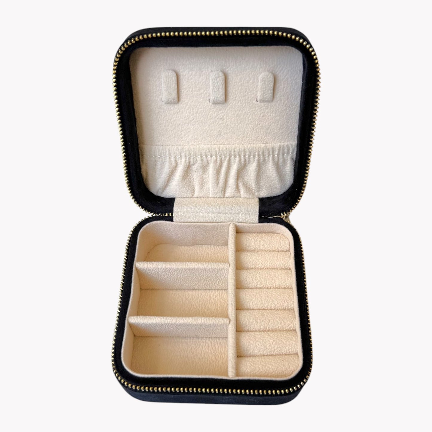 Open black jewelry case with compartments for earrings and rings on a white background