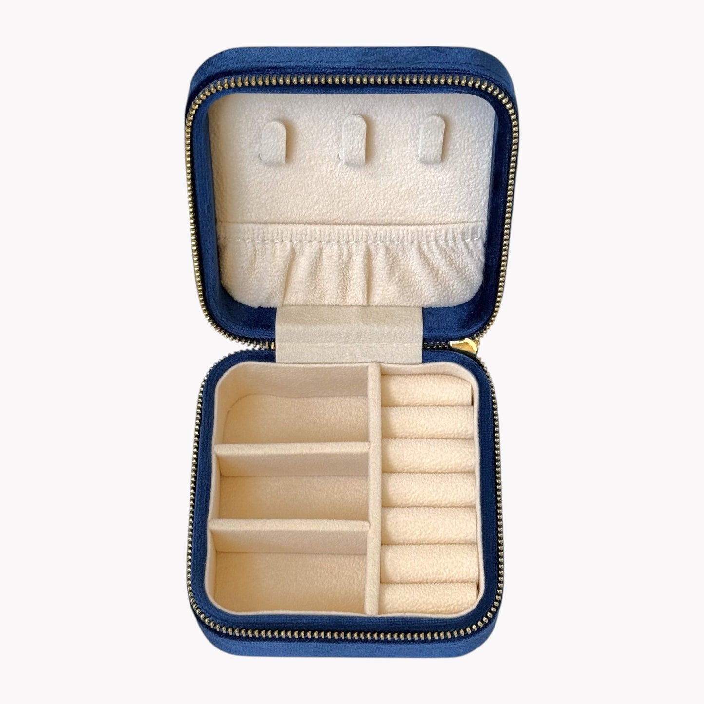 Open blue jewelry case with compartments for earrings and rings on a white background