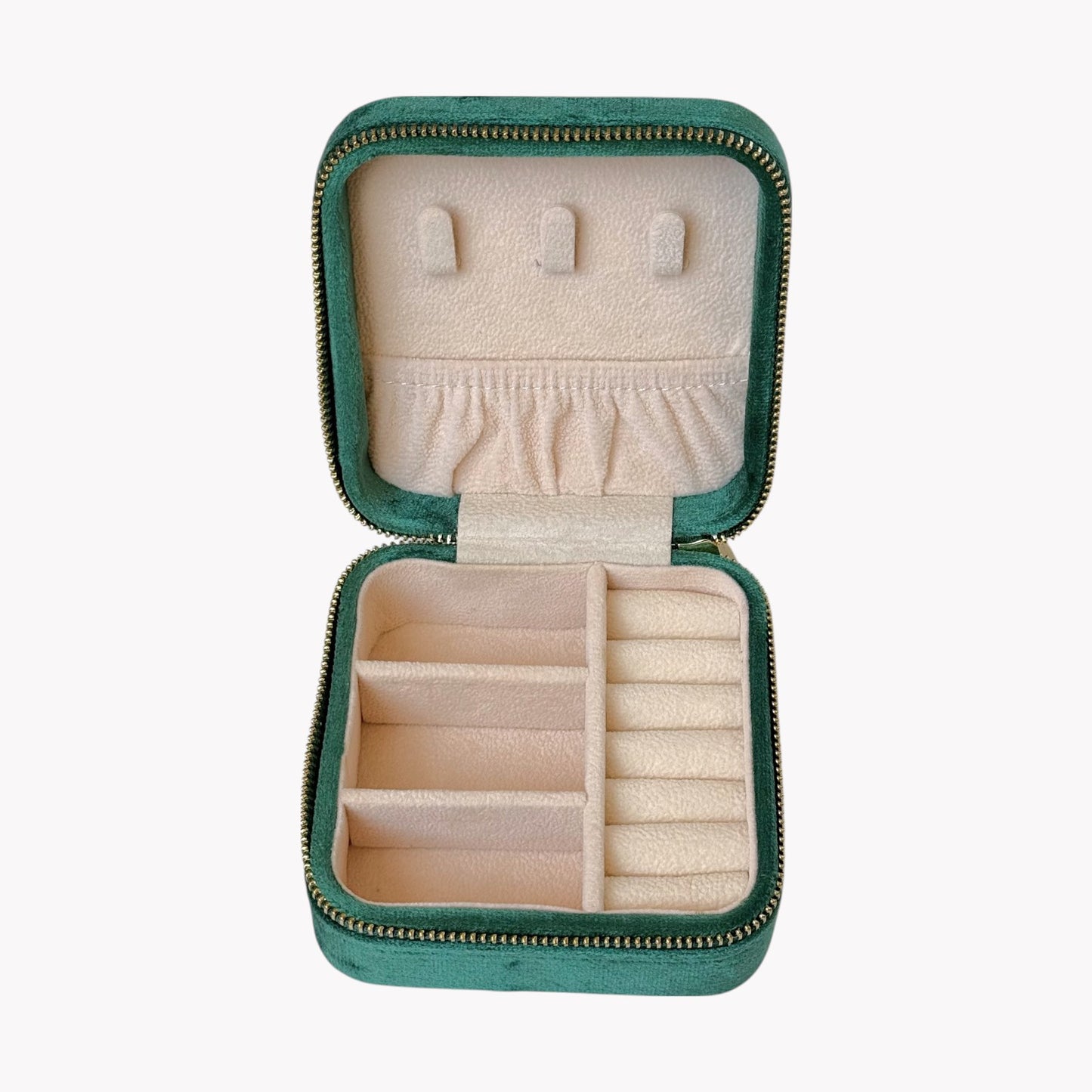 Open green jewelry case with compartments on a white background