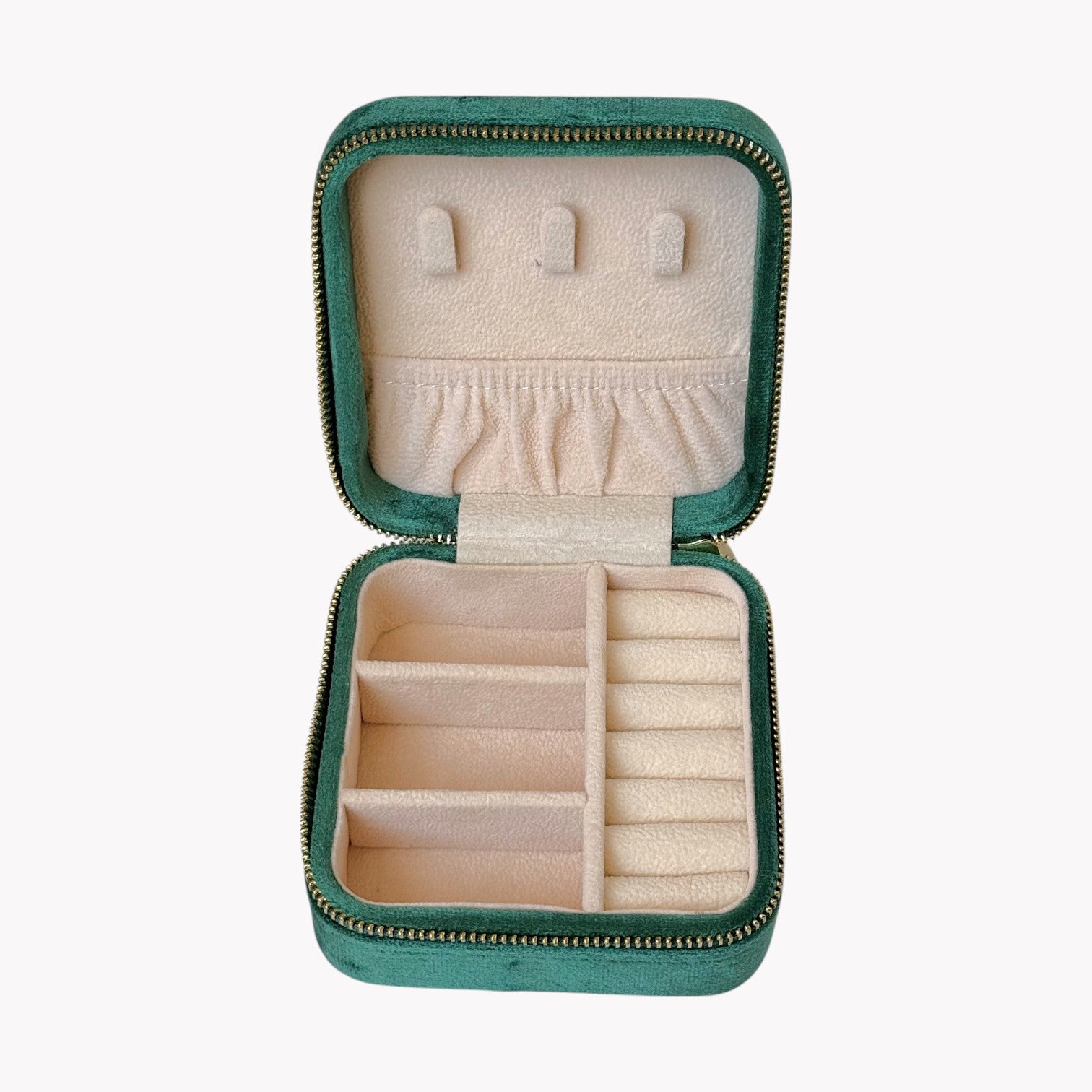 Open green jewelry case with compartments on a white background