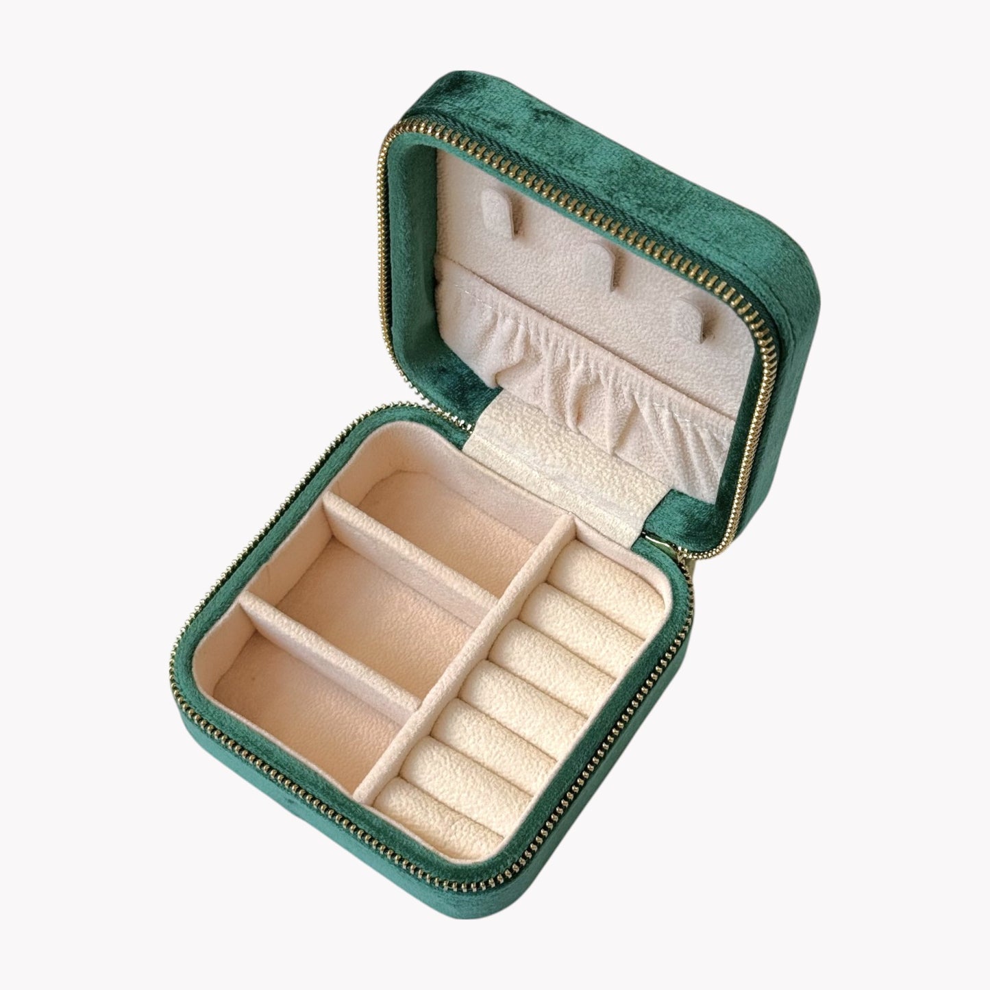 Green jewelry box with beige interior on a white background
