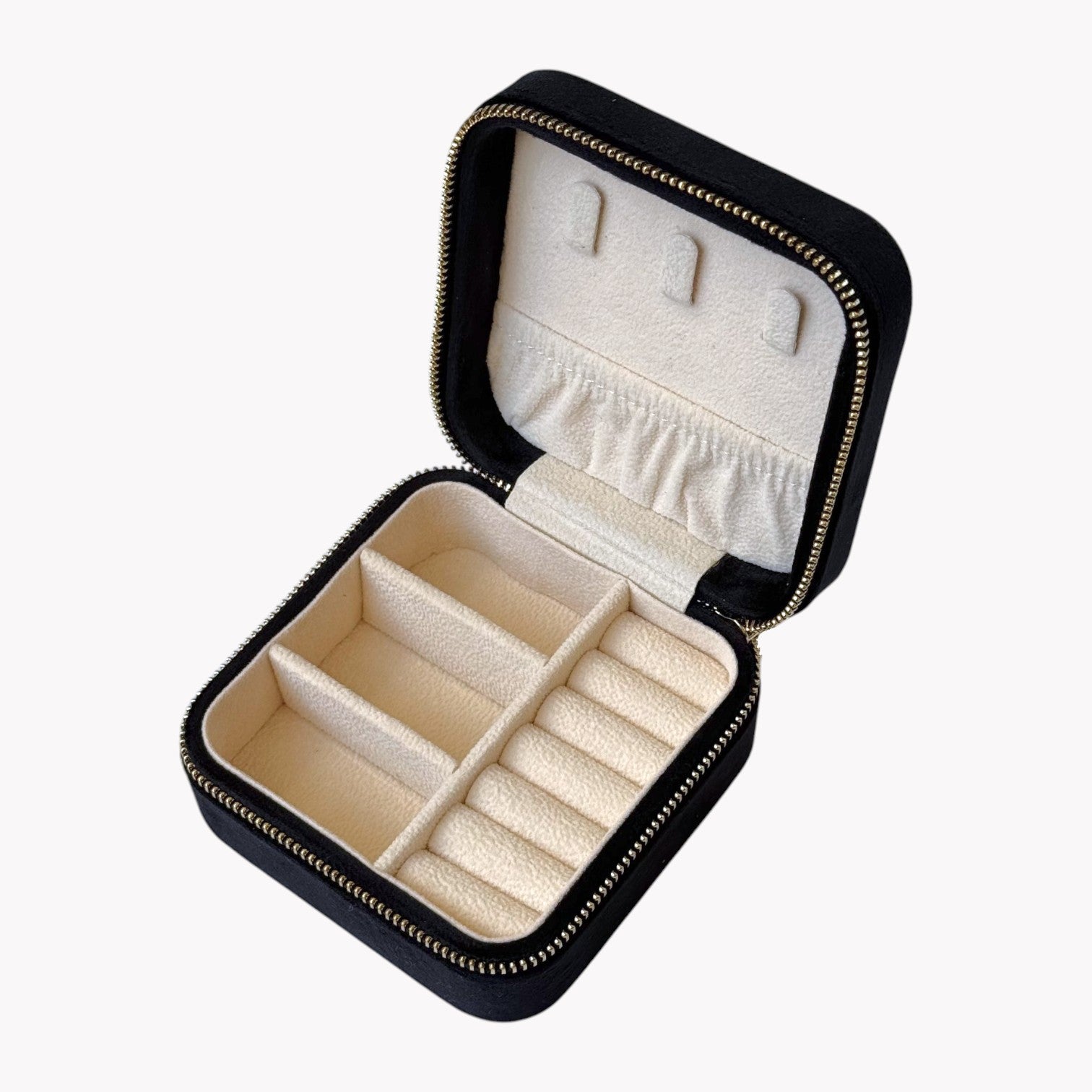 Black jewelry box with beige interior on a white background