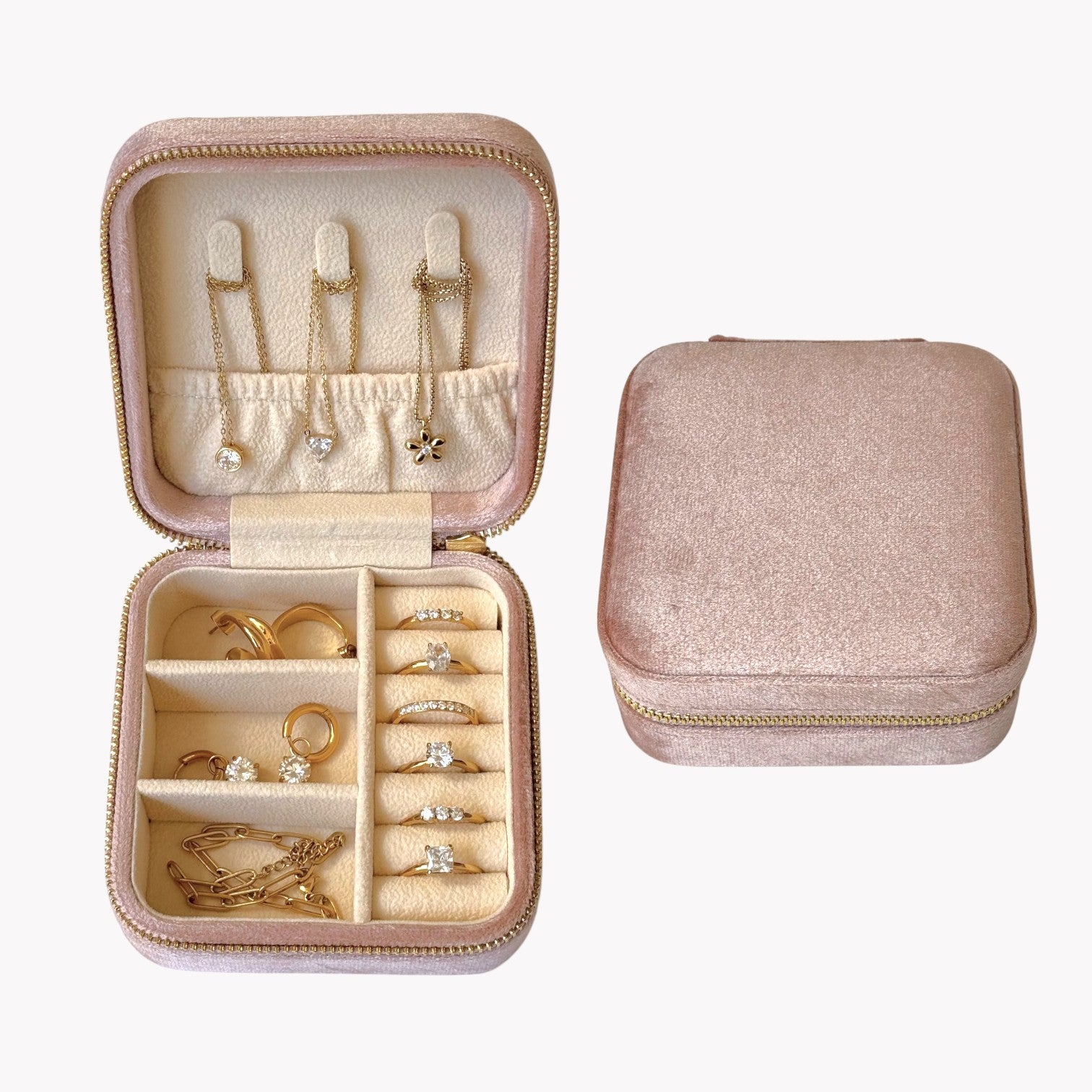 Pink jewelry case with compartments for jewelry on a white background