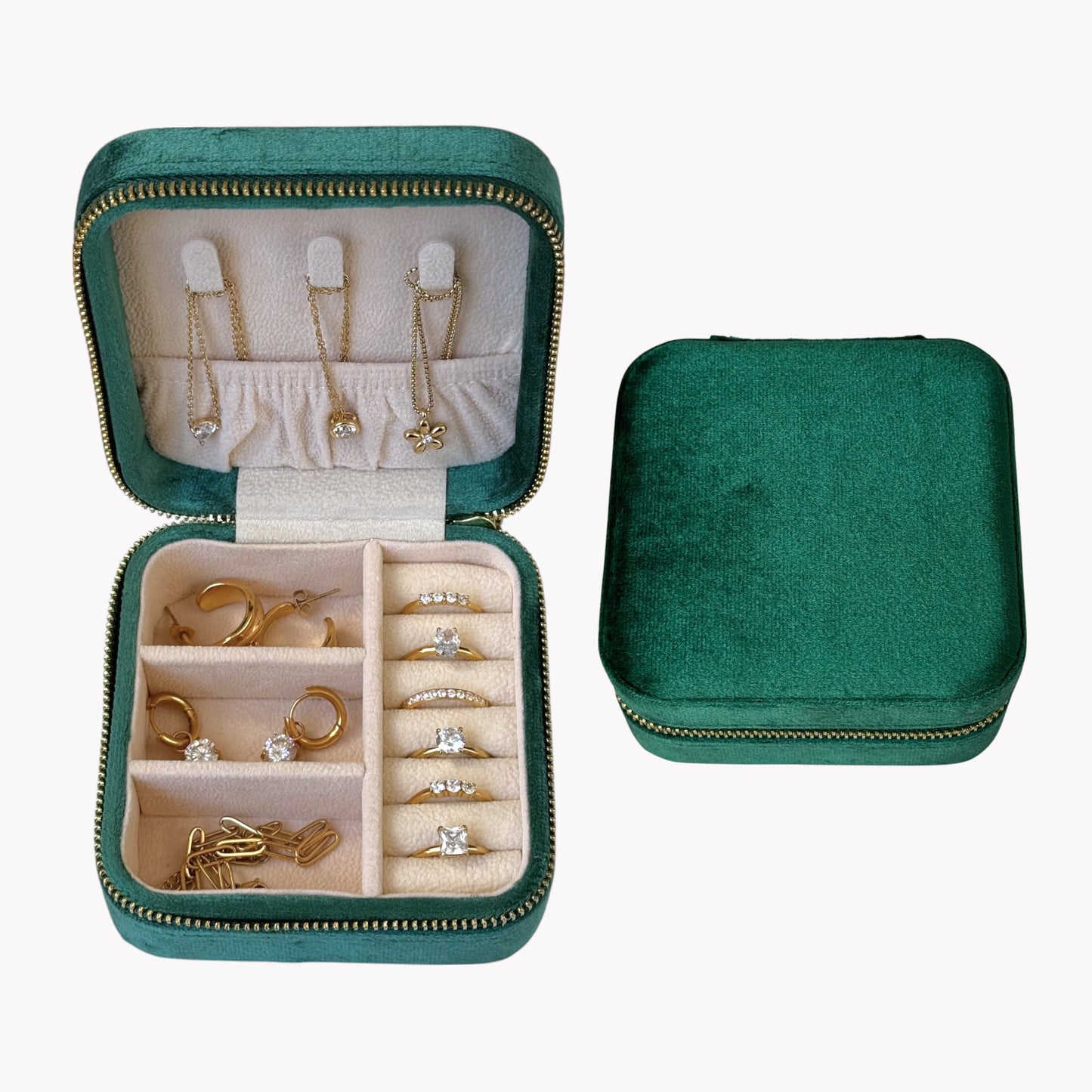 Green jewelry case with compartments for earrings, rings, and necklaces on a white background
