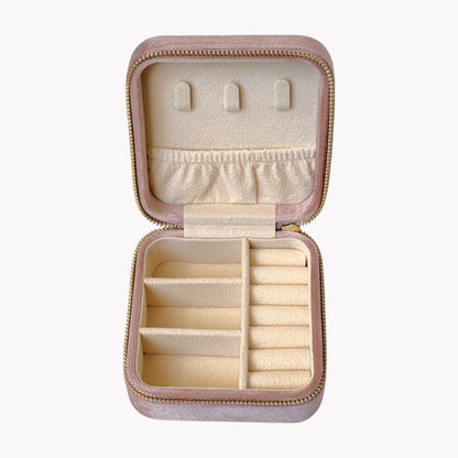Open pink jewelry box with compartments on a white background
