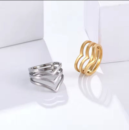 silver and gold layered wishbone ring on a white background