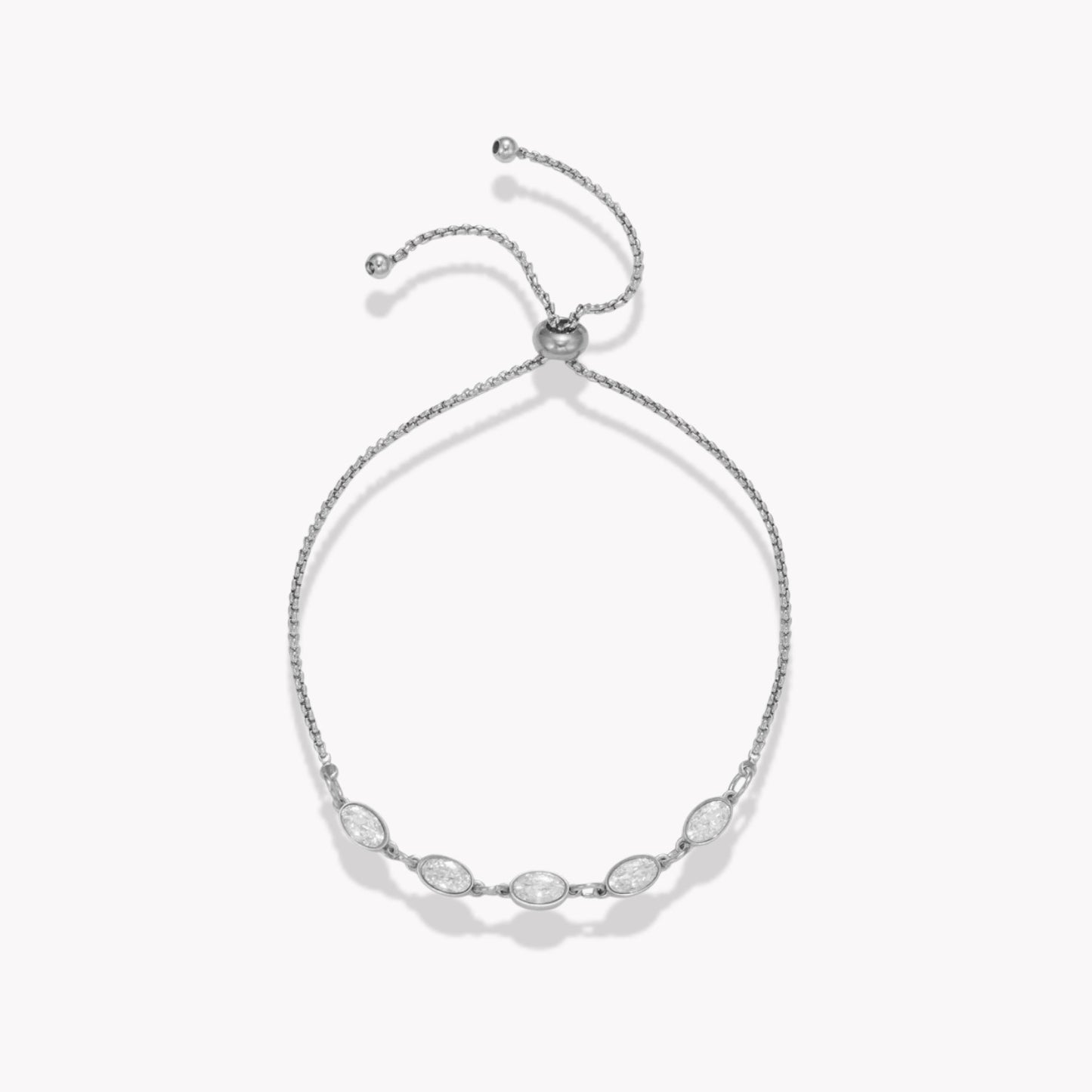 Silver bracelet with five clear oval stones on a white background