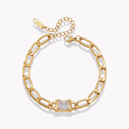 Gold chain bracelet with a central square gemstone on a white background