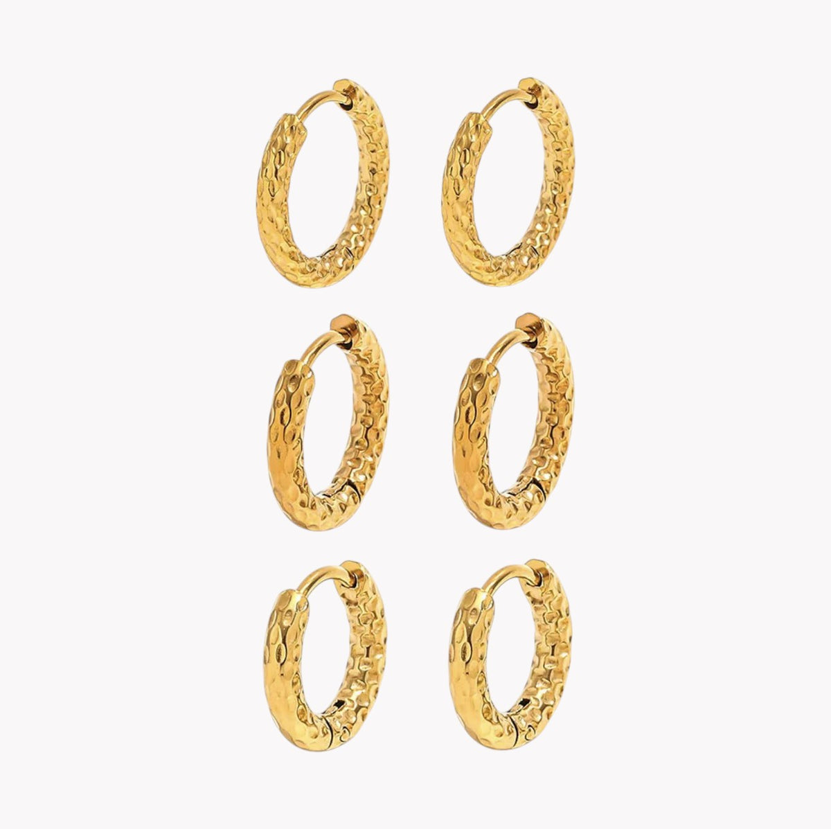 Six pairs of textured gold huggie hoop earrings arranged in a grid on a plain white background.