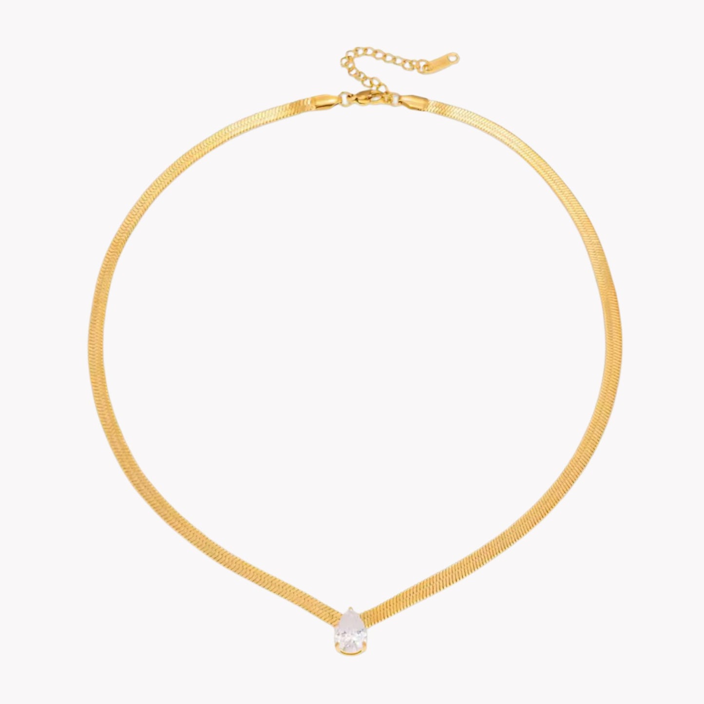 Gold necklace with a small pear pendant on a white background