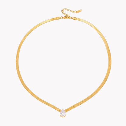 Gold necklace with a small pear pendant on a white background