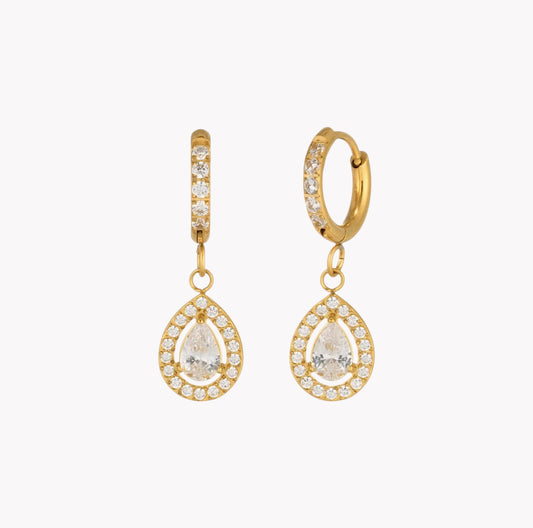 A pair of gold huggie hoop earrings with teardrop-shaped drop pendants, both adorned with clear pavé stones. The clear stones are excluded from color analysis, leaving the gold metal as the sole product color identity.