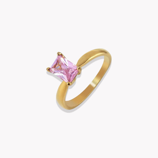 Gold ring with a pink gemstone on a white background