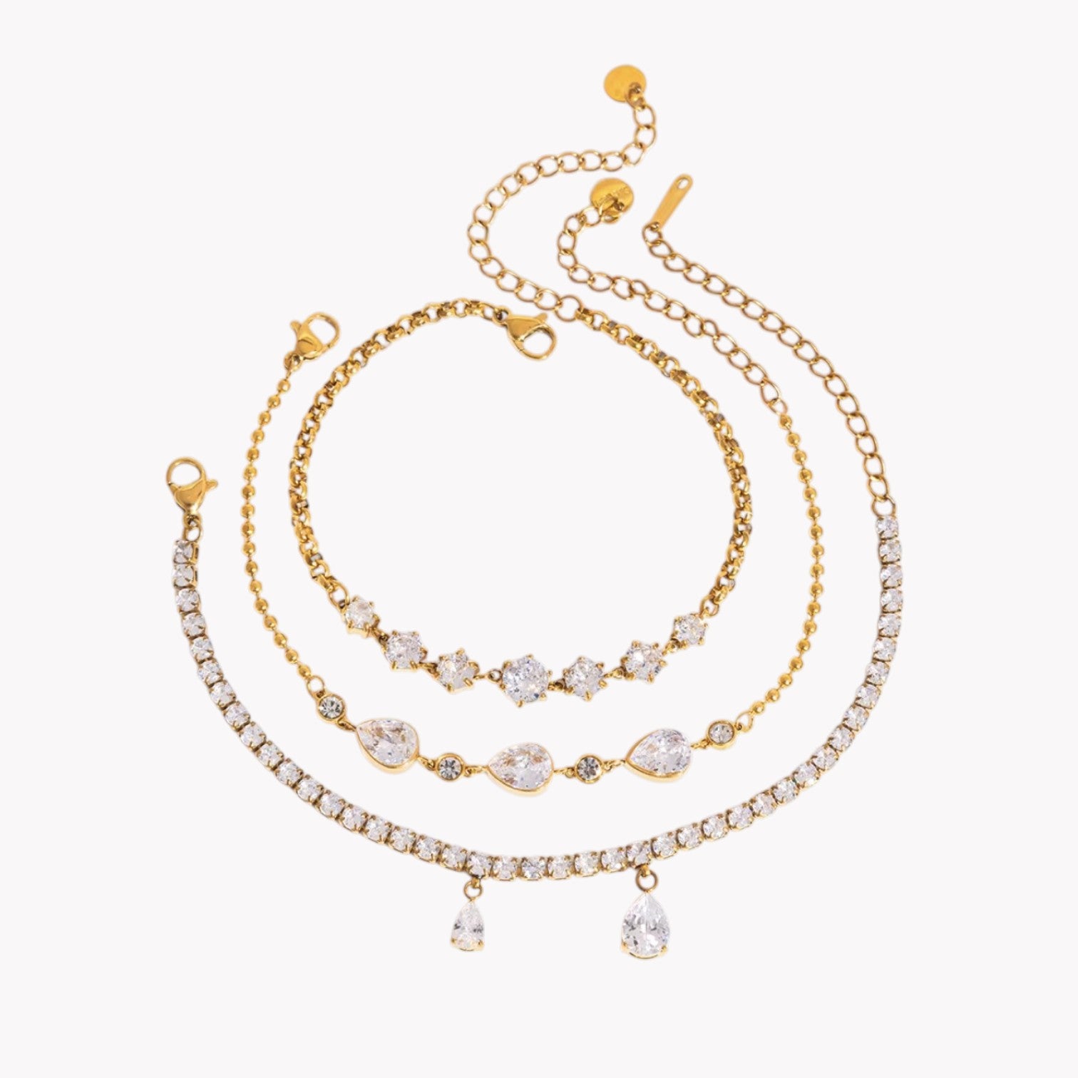 Set of gold and crystal beaded necklaces on a white background