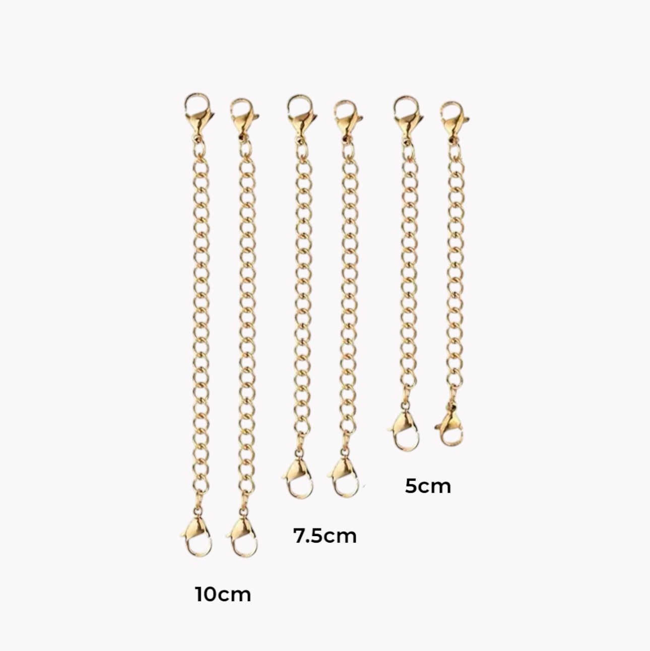 A collection of necklace extenders in gold color with clasps on both ends.