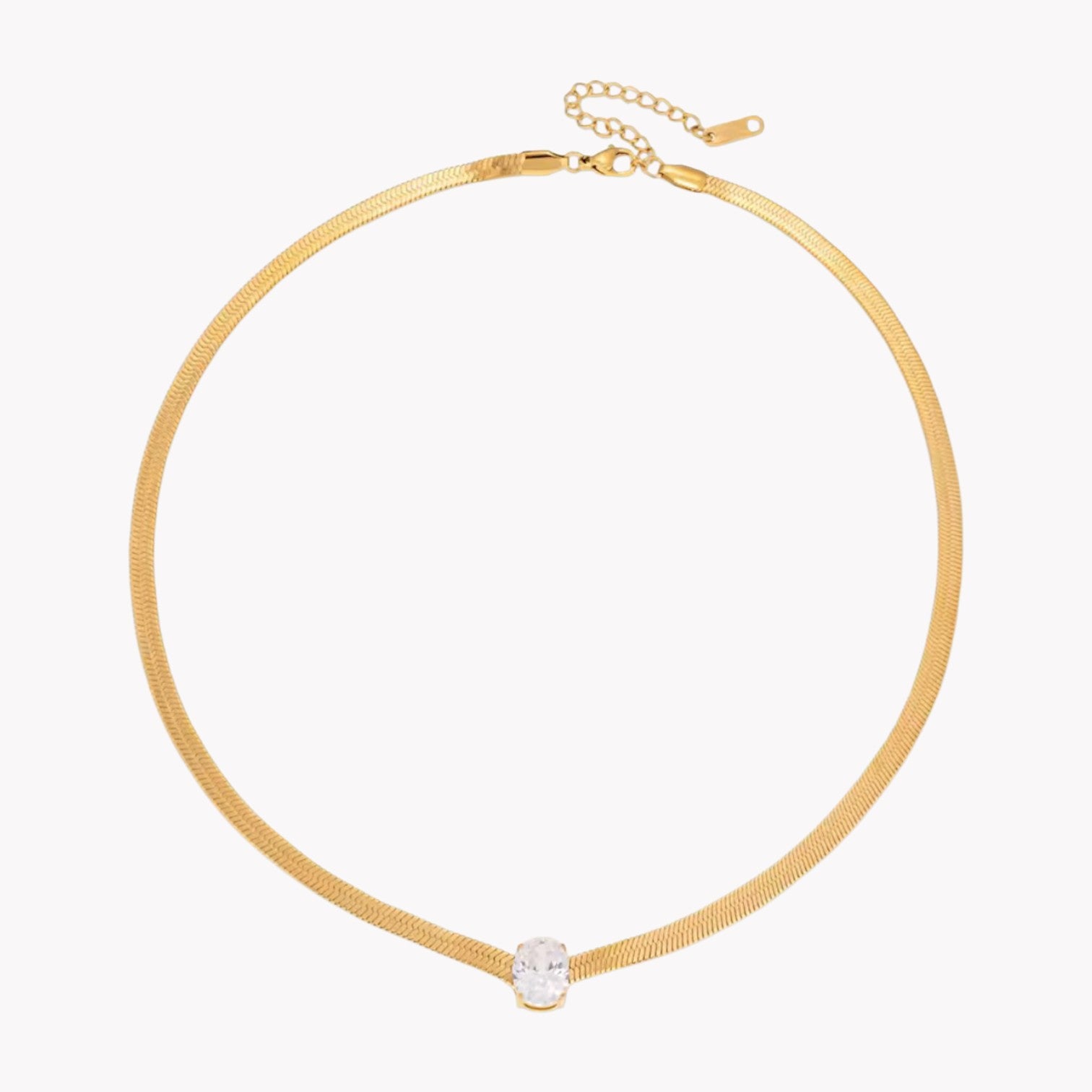 gold necklace with oval gemstone pictured on a white background