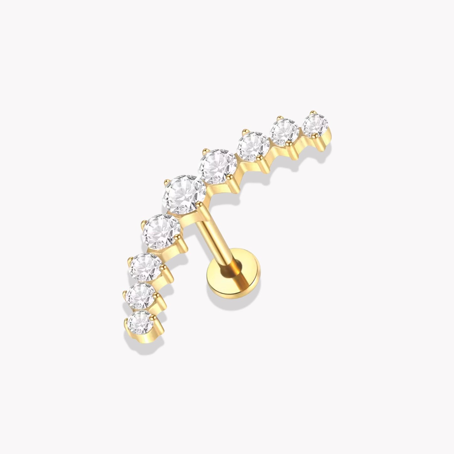 Set of gold earrings with clear gemstones on a white background