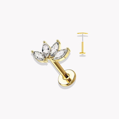 Set of gold earrings with clear gemstones on a white background