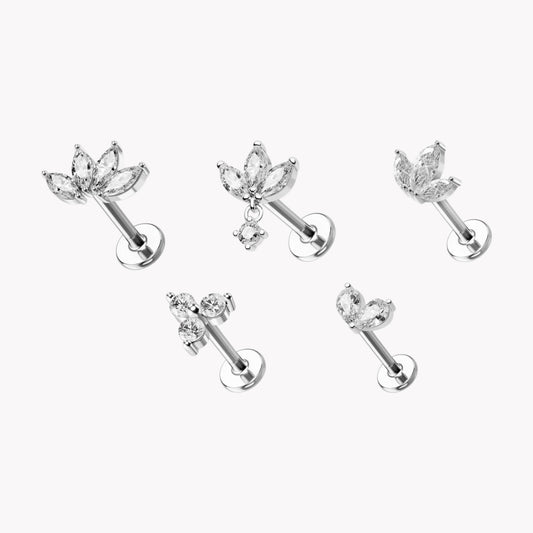 Set of five silver flat back piercing studs with crystal accents on a white background