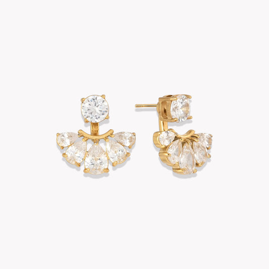 Gold earrings with clear pear shaped gemstones on a white background