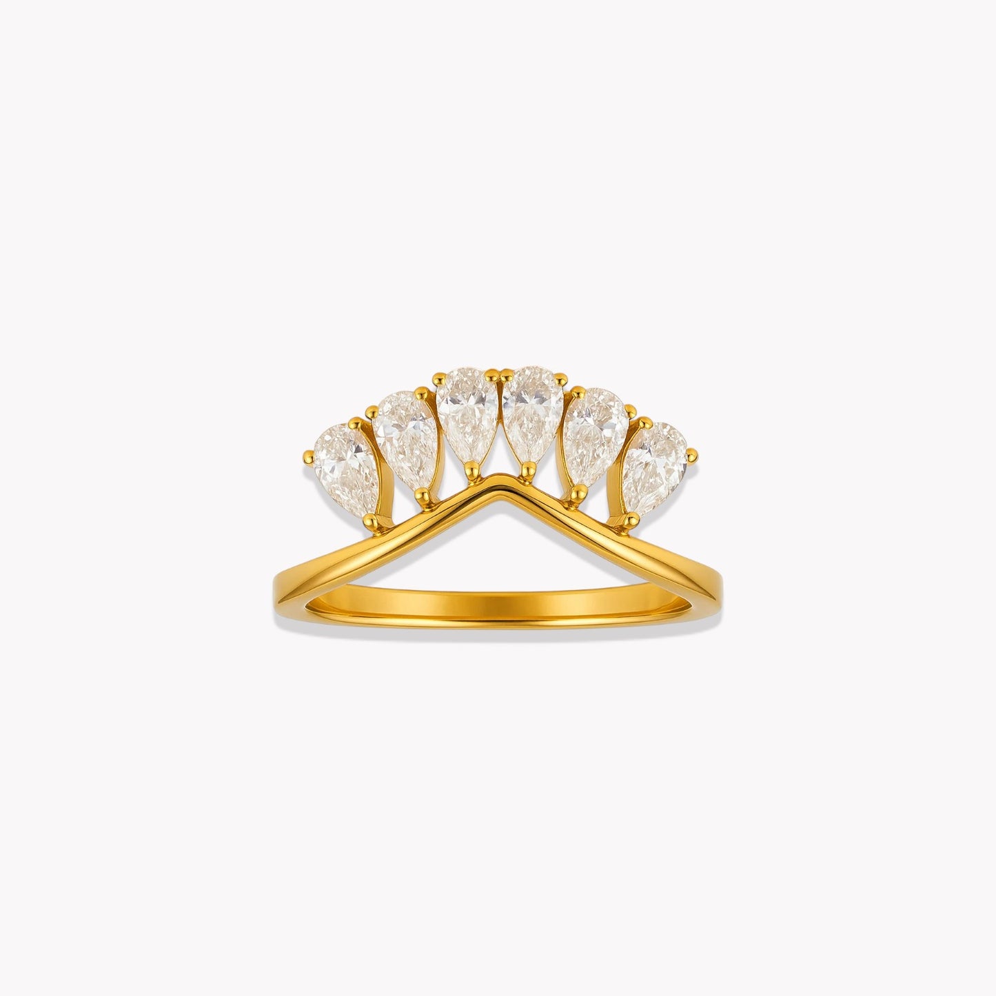 Gold ring with pear-shaped diamonds on a white background