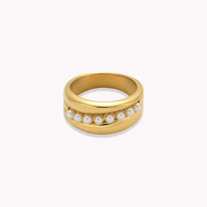 Gold ring with pearls on a white background
