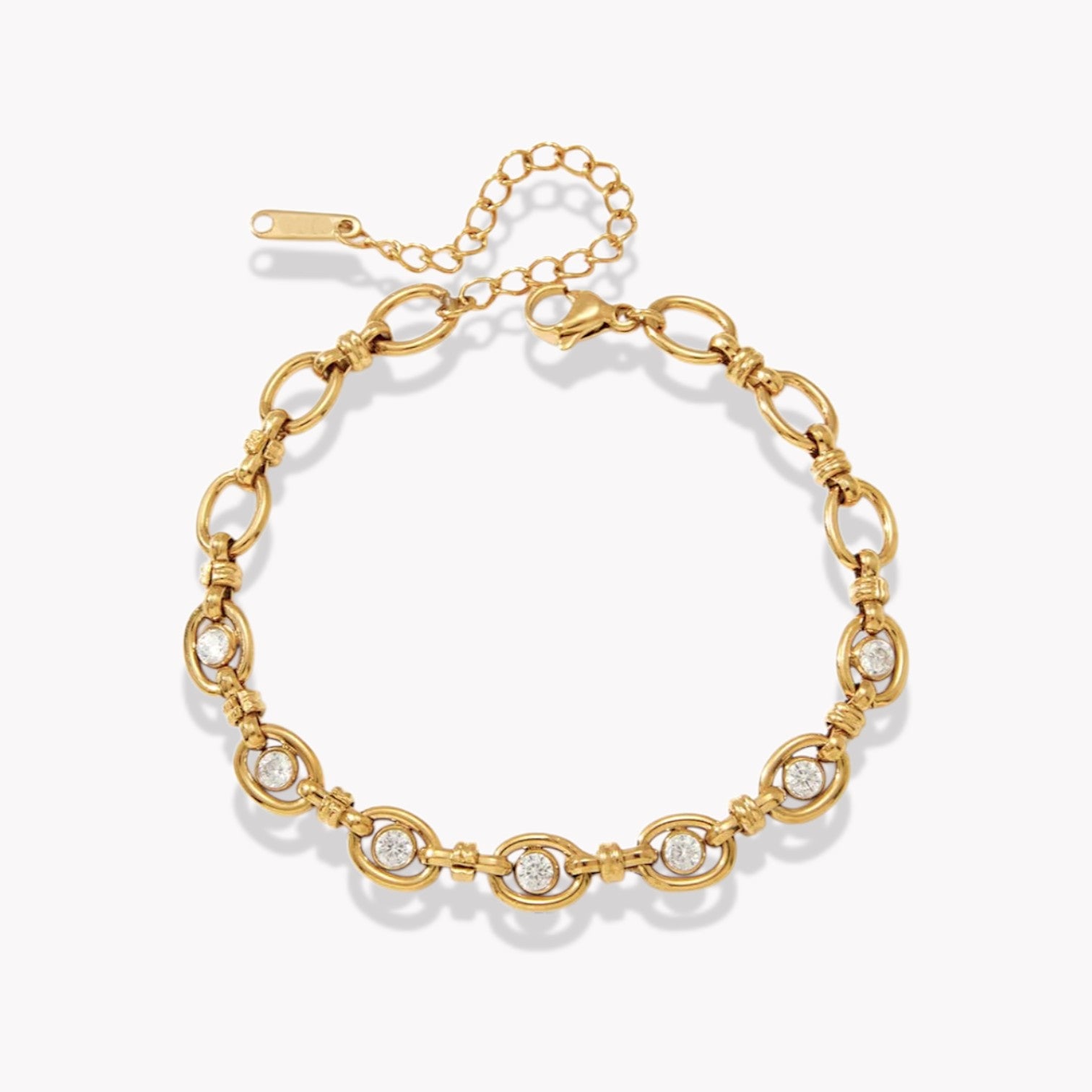 gold bracelet with genstones pictured on a light grey background