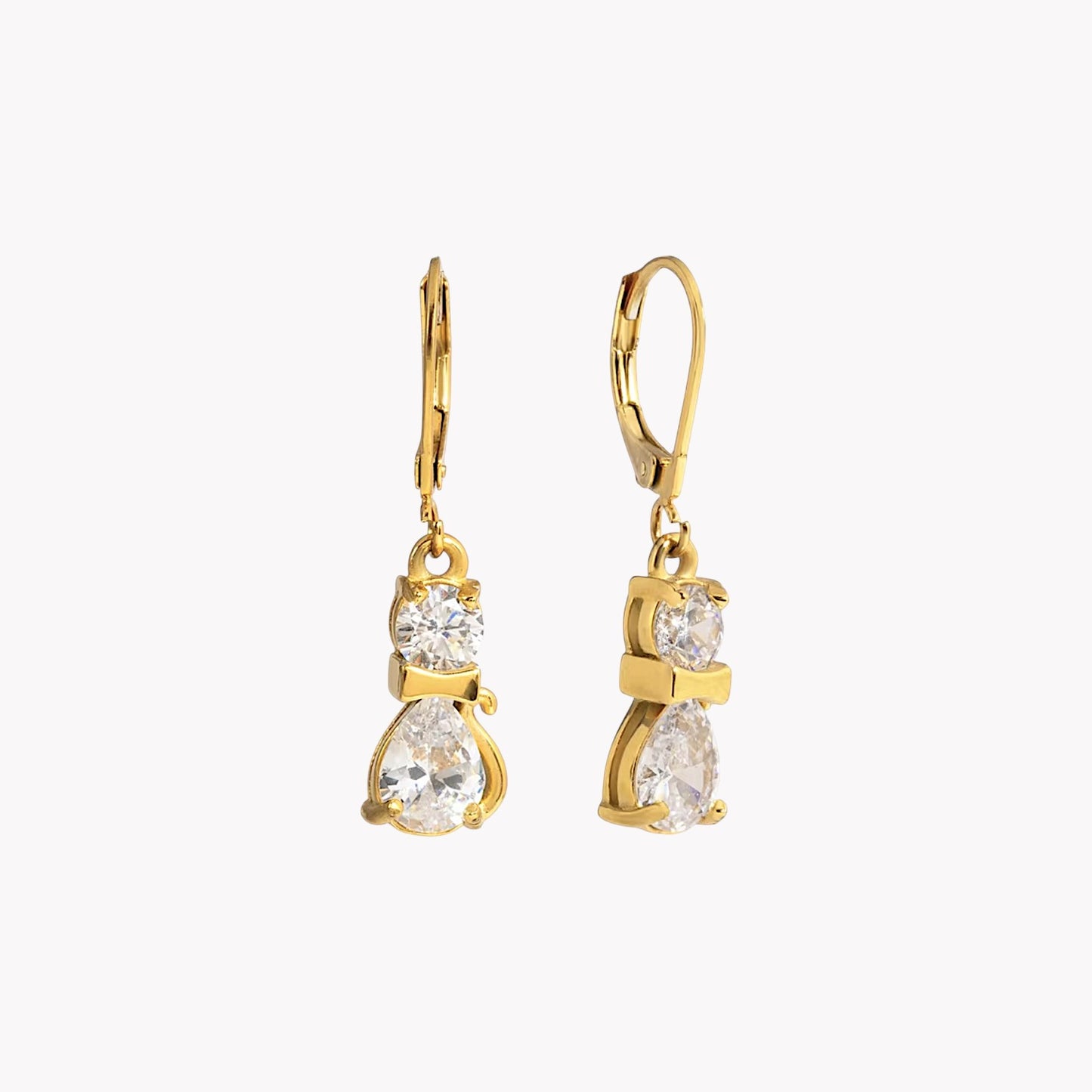 Gold earrings with clear gemstones on a white background