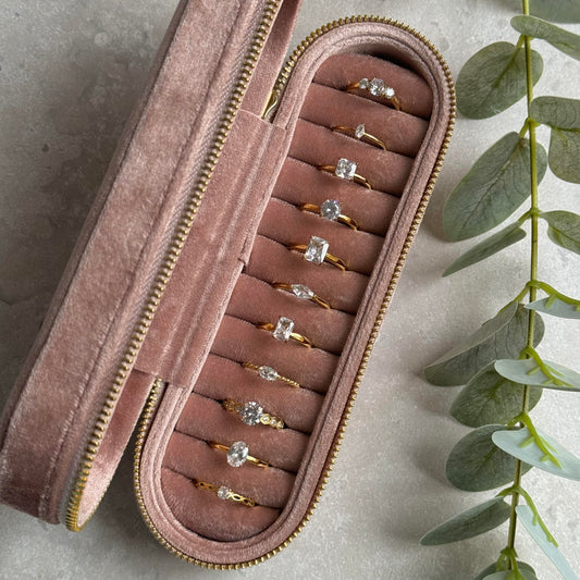 Dusky Pink jewelry case with gold rings on a light grey background