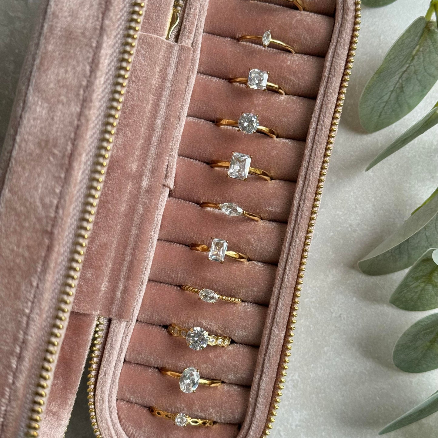 Dusky Pink jewelry case with gold rings on a light grey background