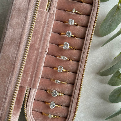 Dusky Pink jewelry case with gold rings on a light grey background