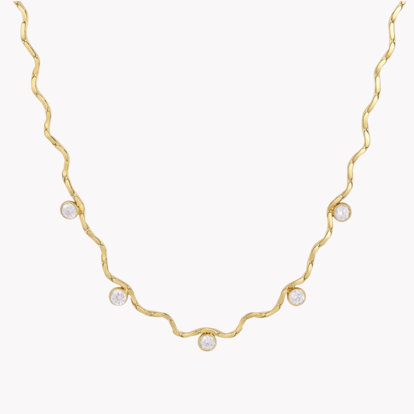 A delicate gold necklace with a wavy, twisted design and five small clear round gemstones spaced along the chain, shown against a plain white background.