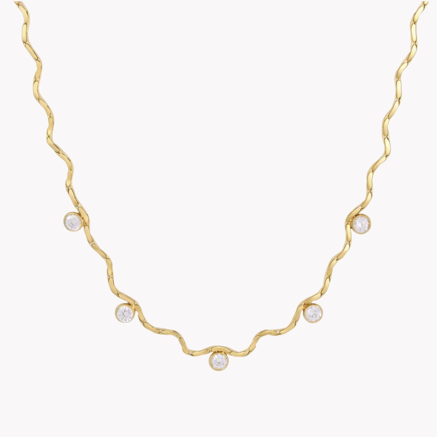 A delicate gold necklace with a wavy, twisted design and five small clear round gemstones spaced along the chain, shown against a plain white background.