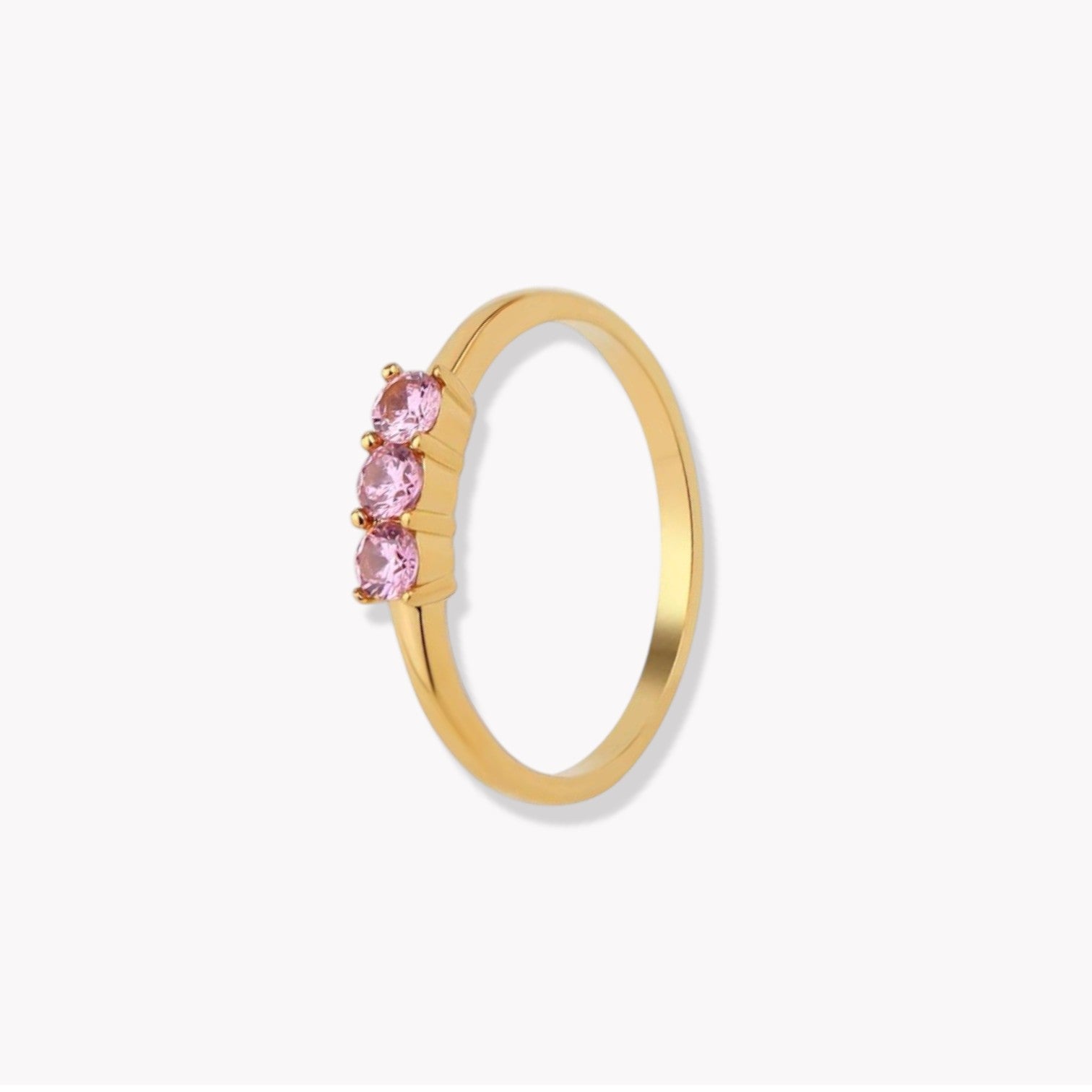 gold wing with pink gemstones on a light grey background