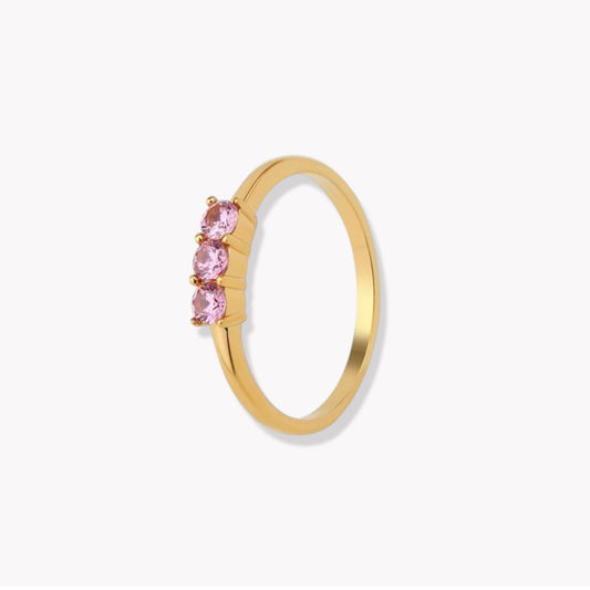 gold wing with pink gemstones on a light grey background