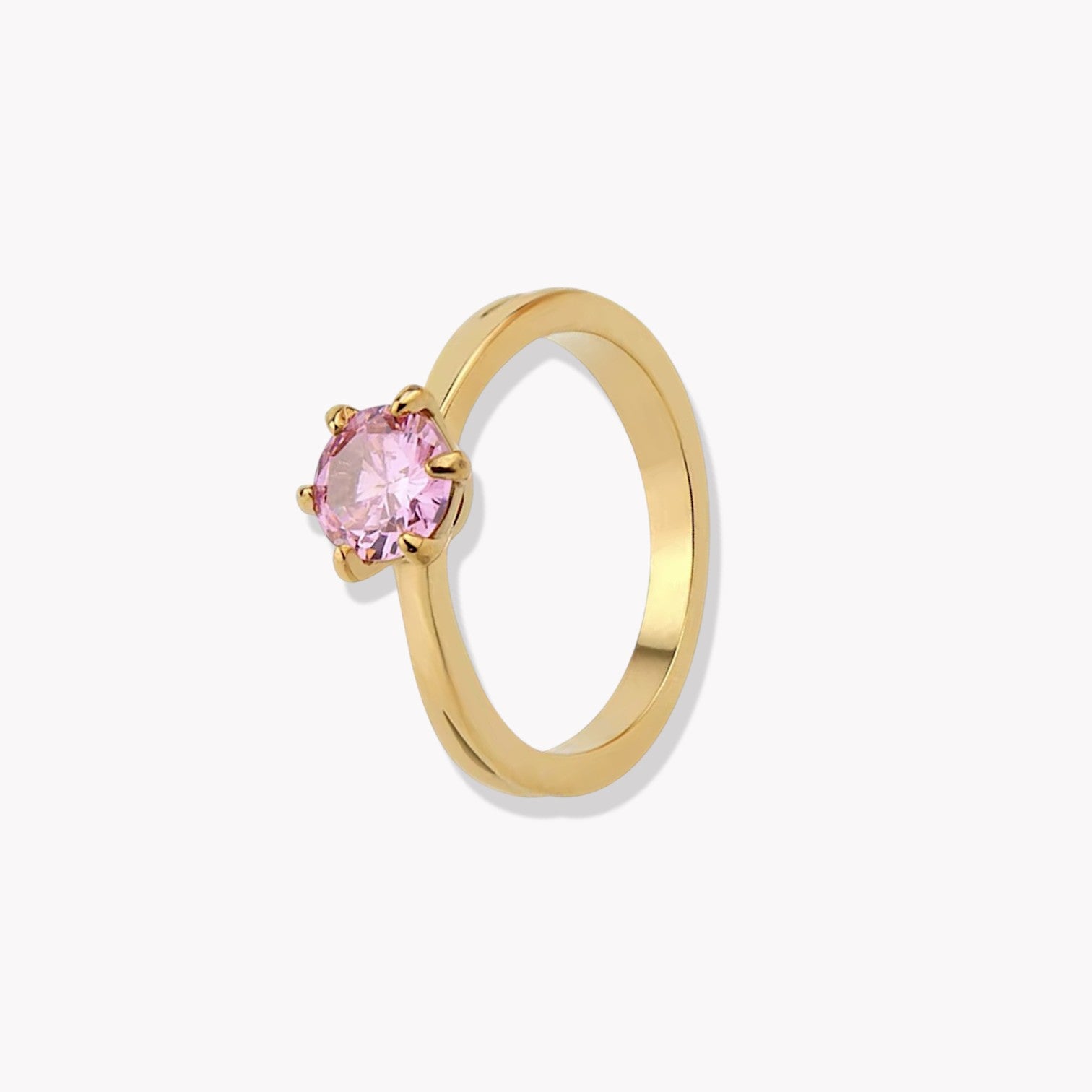 Gold ring with a pink gemstone on a white background