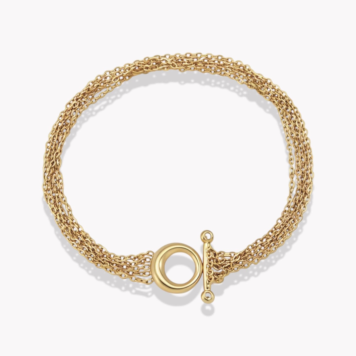 Gold bracelet with chain detail on a light coloured background