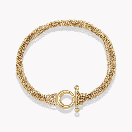 Gold bracelet with chain detail on a light coloured background