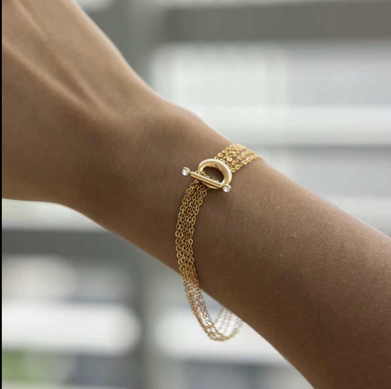 Close up of a gold bracelet being worn on a wrist