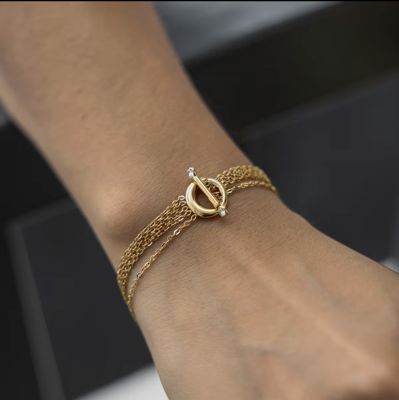 Close up of a gold bracelet being worn on a wrist