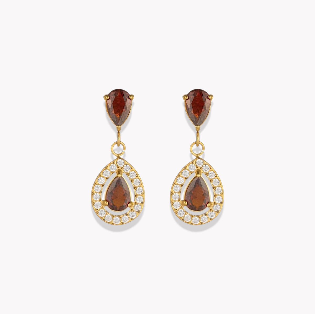 A pair of gold drop earrings featuring pear-cut brown gemstones in the top and center, surrounded by small clear pavé stones in teardrop-shaped settings, shown on a light gray background.