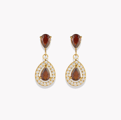 A pair of gold drop earrings featuring pear-cut brown gemstones in the top and center, surrounded by small clear pavé stones in teardrop-shaped settings, shown on a light gray background.