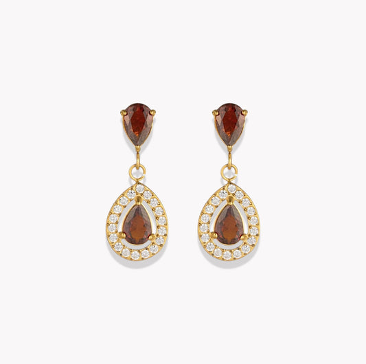 A pair of gold drop earrings featuring pear-cut brown gemstones in the top and center, surrounded by small clear pavé stones in teardrop-shaped settings, shown on a light gray background.