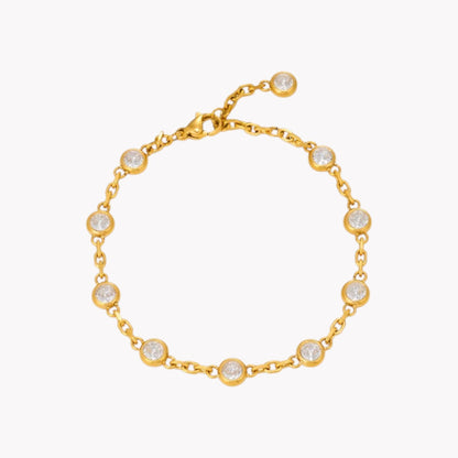 A gold chain bracelet with eight bezel-set clear round stones, displayed on a clean white background.